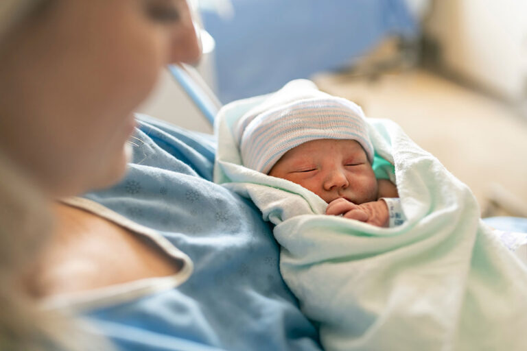 woman holding new born baby